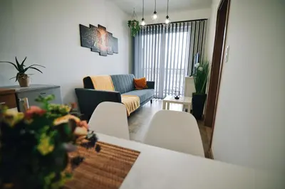 a living room with a couch and a table and chairs at Apartament 30tka by Housine in Zator
