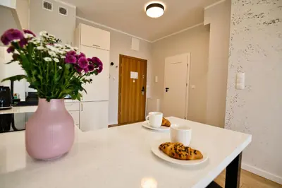 a kitchen with a vase of flowers and a plate of food at Pastel 47 by Housine in Zator