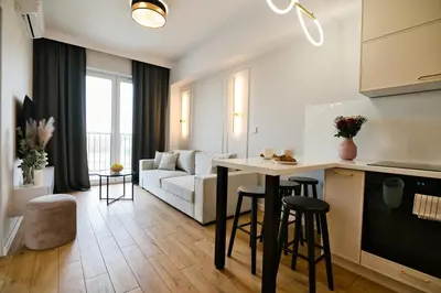 a living room with a bowl of apples on a glass table at Pastel 47 by Housine in Zator