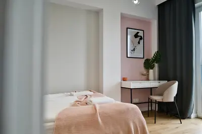 a bed with two pink pillows on top of it at Pastel 47 by Housine in Zator