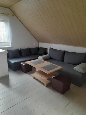 a living room with a couch and a table at Mieszkanie B Łowiczki in Zator