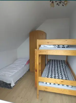 a bedroom with two bunk beds and a bed at Mieszkanie B Łowiczki in Zator