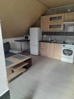 a kitchen with a white refrigerator and a stove at Mieszkanie B Łowiczki in Zator