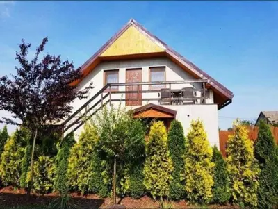 a house with a balcony on the side of it at Mieszkanie B Łowiczki in Zator