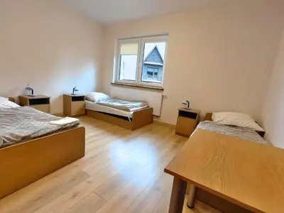 a room with two beds and a window at Karmelitański Dom Gościnny in Zawoja