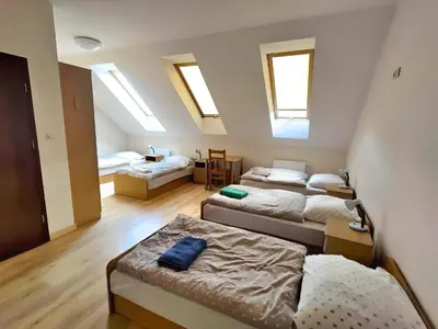 a room with three beds and a room with skylights at Karmelitański Dom Gościnny in Zawoja