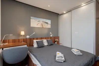a bedroom with a bed with a desk and a chair at Superior Apartment with Terrace & Free Parking in Kraków