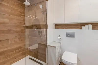 a bathroom with a toilet and a glass shower at Superior Apartment with Terrace & Free Parking in Kraków