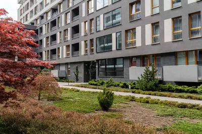 a building with a garden in front of a building at Superior Apartment with Terrace & Free Parking in Kraków