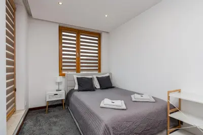 a bedroom with a bed and a window at Superior Apartment with Terrace & Free Parking in Kraków