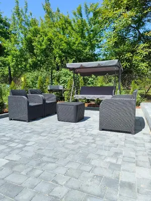 a group of chairs and an umbrella on a patio at Apartamenty Wadowity- Energylandia Zator in Wadowice