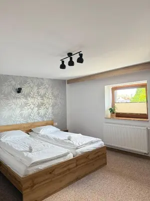 a bedroom with a bed and a window at Apartamenty Wadowity- Energylandia Zator in Wadowice