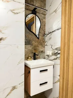 a bathroom with a white sink and a mirror at Apartamenty Wadowity- Energylandia Zator in Wadowice