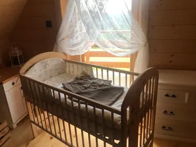 a crib in a room with a window at Pacygówka in Skawica