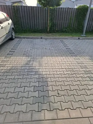 a brick parking lot with a car parked on it at Bagry Rooms3 LoveKrakow in Kraków