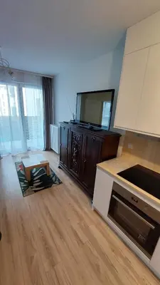 a living room with a kitchen with a counter top at Bagry Rooms3 LoveKrakow in Kraków