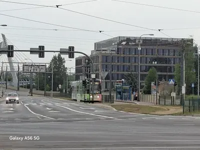 a bus driving down a street with a building at Bagry Rooms3 LoveKrakow in Kraków