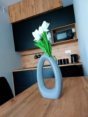 a blue vase with white flowers sitting on a table at GOOD PLACE Zator in Zator
